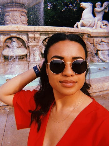 person wearing black sunglasses with rounded wire frames 