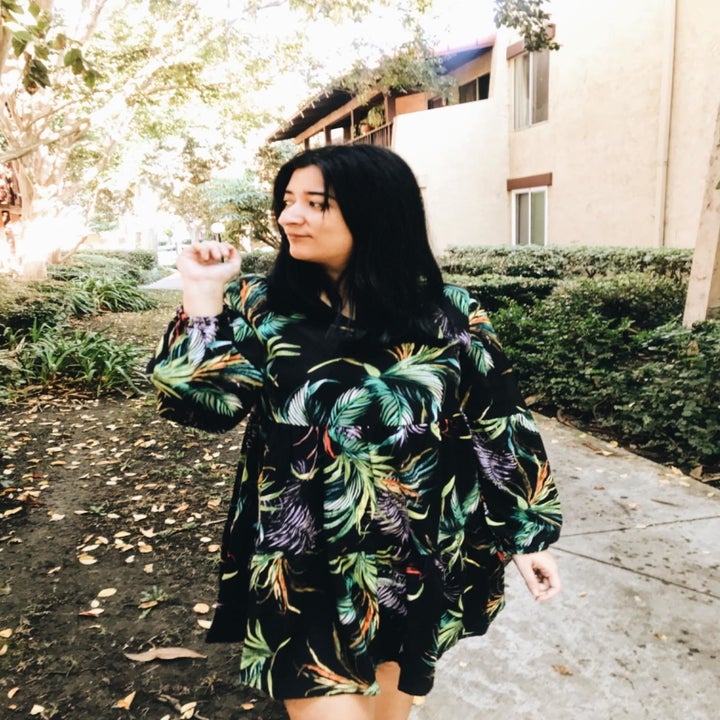 reviewer wears dress in leafy design 