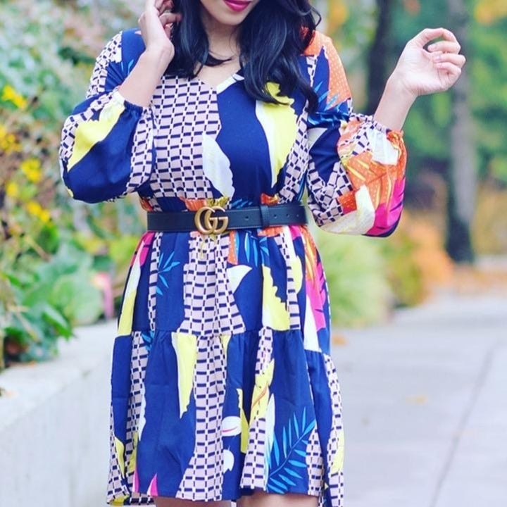 reviewer wears dress with three quarter sleeve and geometric design 