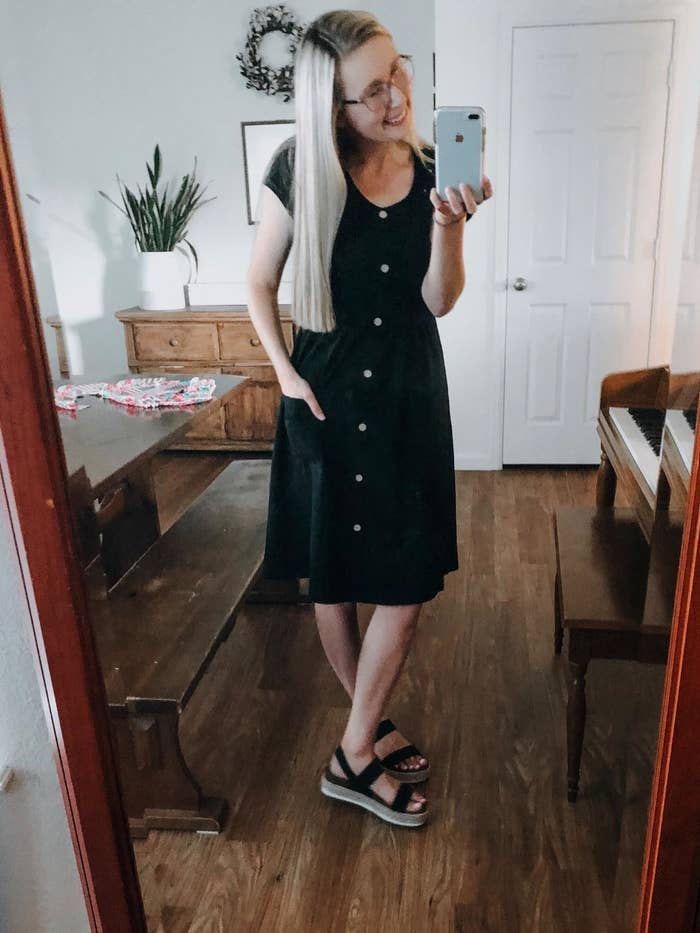 reviewer wears short sleeve midi dress with buttons down the front 