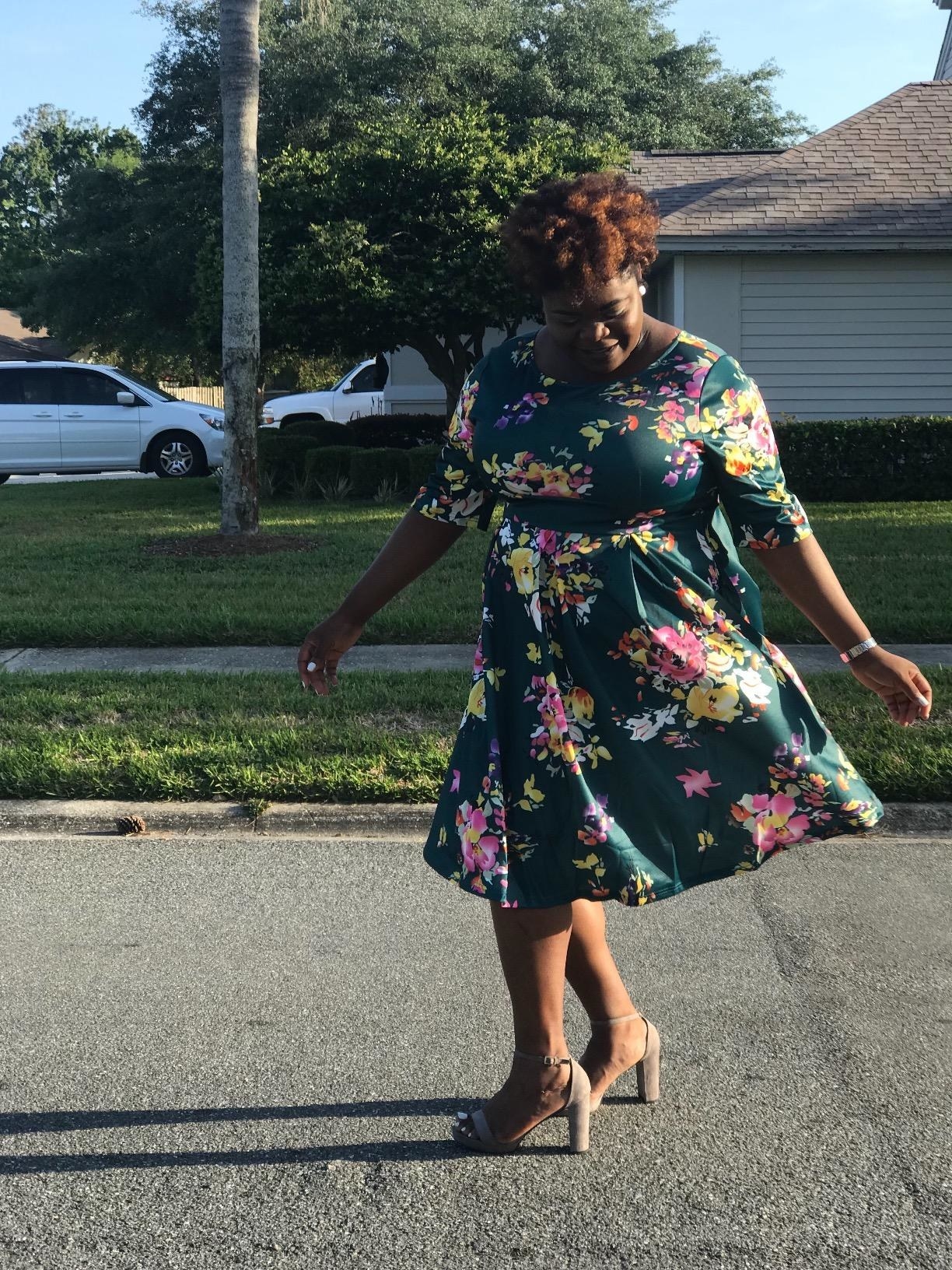 reviewer twirls in floral skater dress with half sleeves 