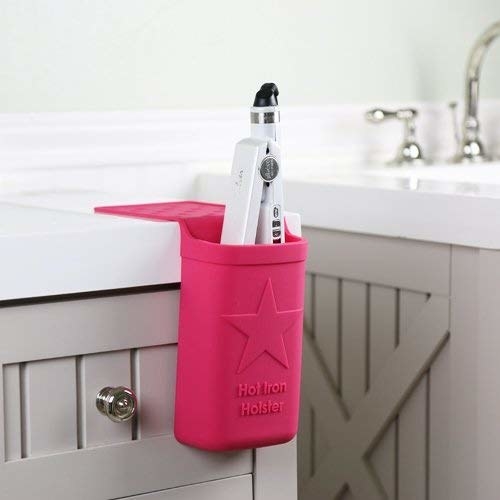 The silicone holster stuck to the countertop and holding a straightener
