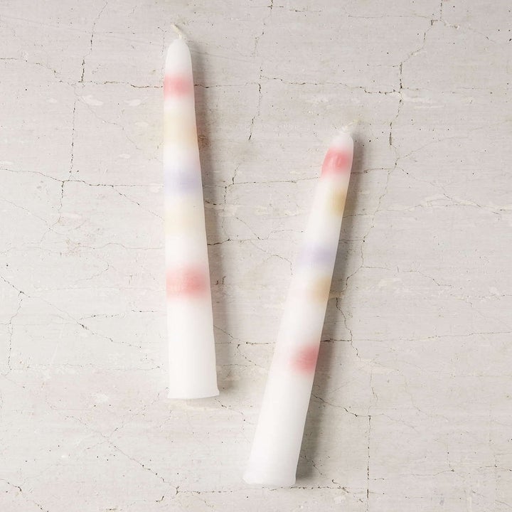 Long white candlesticks with multi colored phases inside 