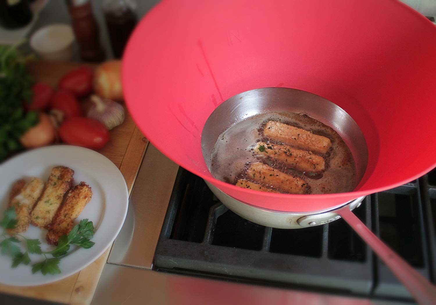 top down view of frying pan with sausage in it with the guard on the side 