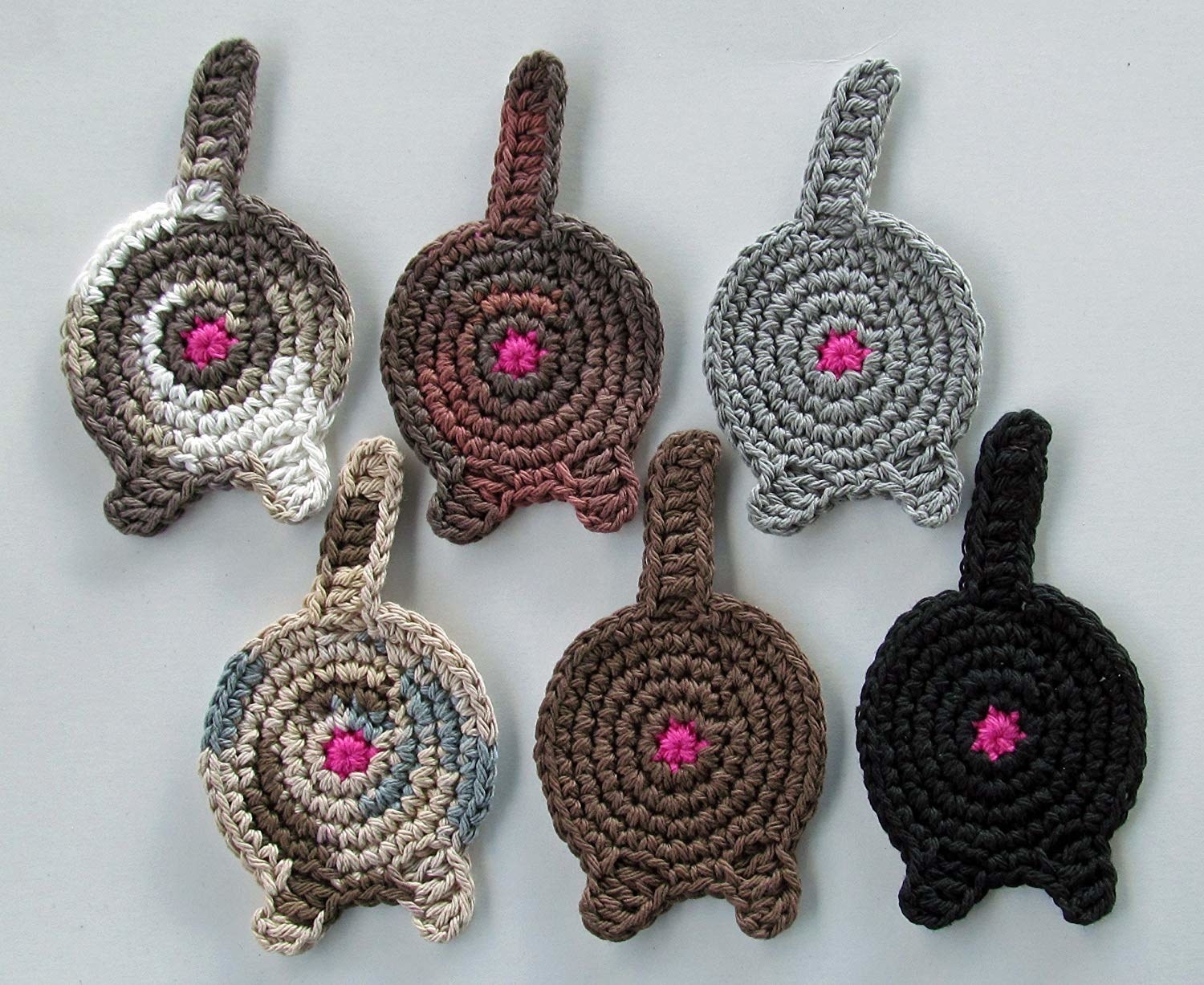 A set of crocheted cat butt coasters