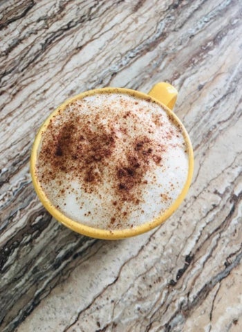 reviewer image of a latte topped with foam and cinnamon