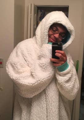 a reviewer wearing the snuggly blanket sweatshirt in white