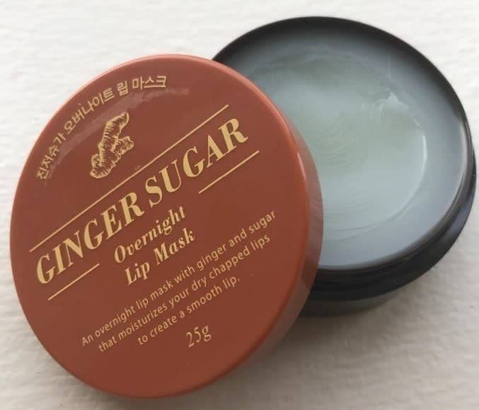 The open jar of the lip mask — the mask itself is a clearish color