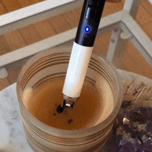 A Gif of BuzzFeed shopping editor Heather Braga lighting a candle with the electric lighter 