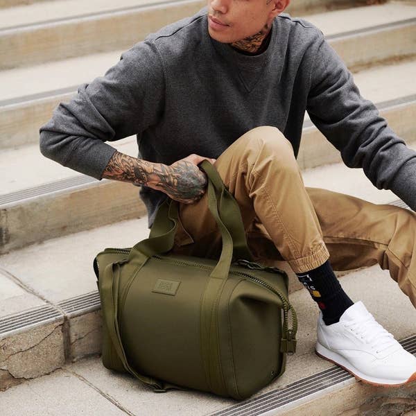 model holding a green dagne dover bag