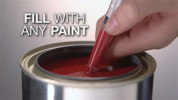 a person filling the paint pet with red paint