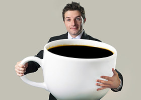 Happy Businessman Holding Funny Huge Oversized Cup Of Black Cof