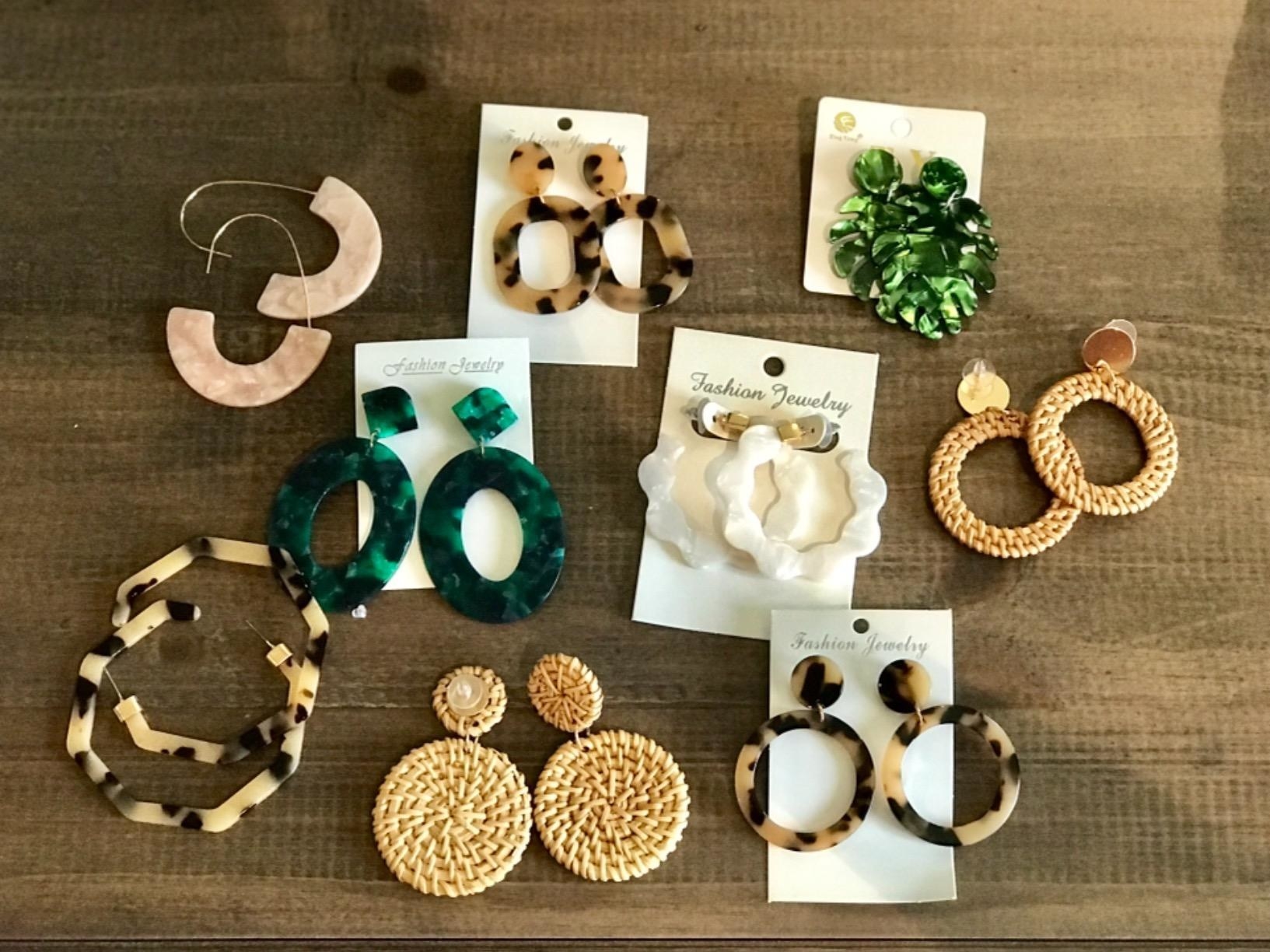 a variety of statement earrings laid out