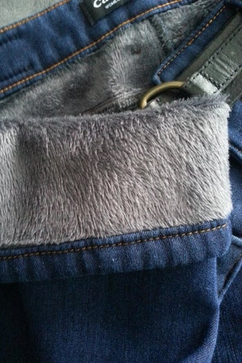 The inside of a reviewer's pair of jeans; the fleece is grey and fuzzy