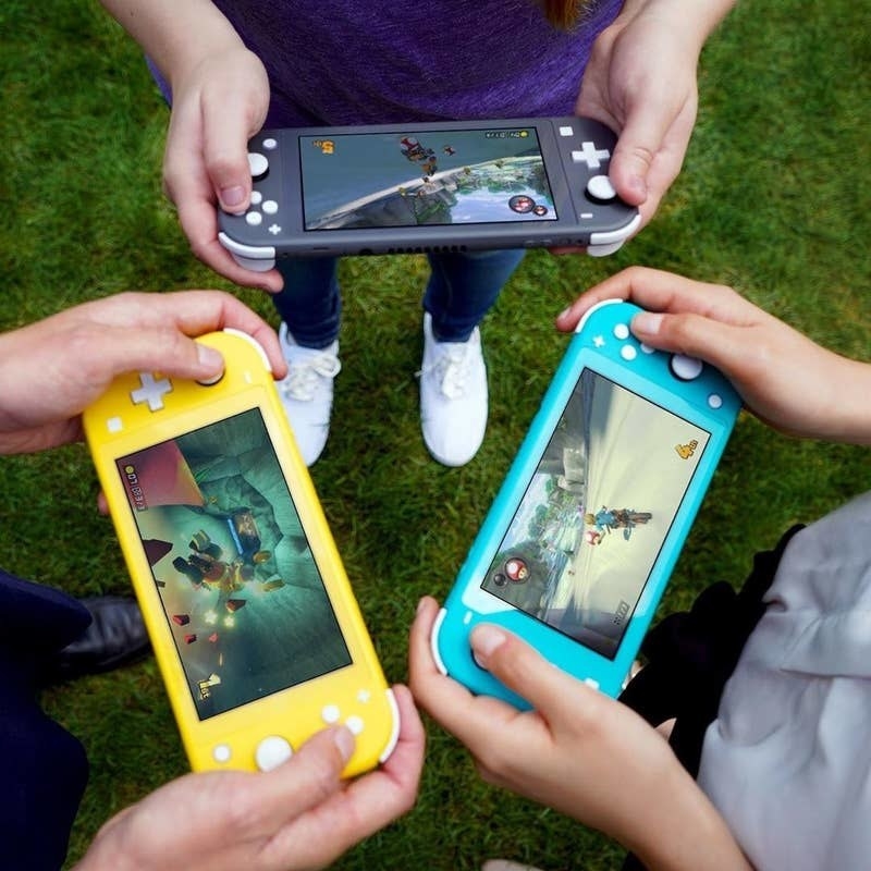 three pairs of hands holding yellow, teal, and black nintendo switch lites