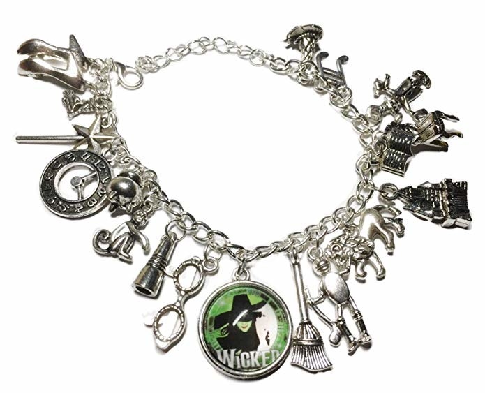 The silver bracelet with a lot of assorted charms related to the musical Wicked, including a broom, glasses, clock, want, and more, plus a green charm with the logo for the show