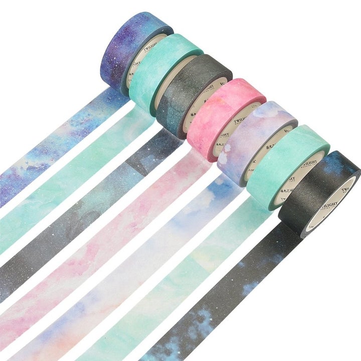 Seven rolls of washi tape on a plain background