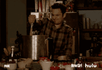 nick from new girl grimacing and stirring a huge pot 