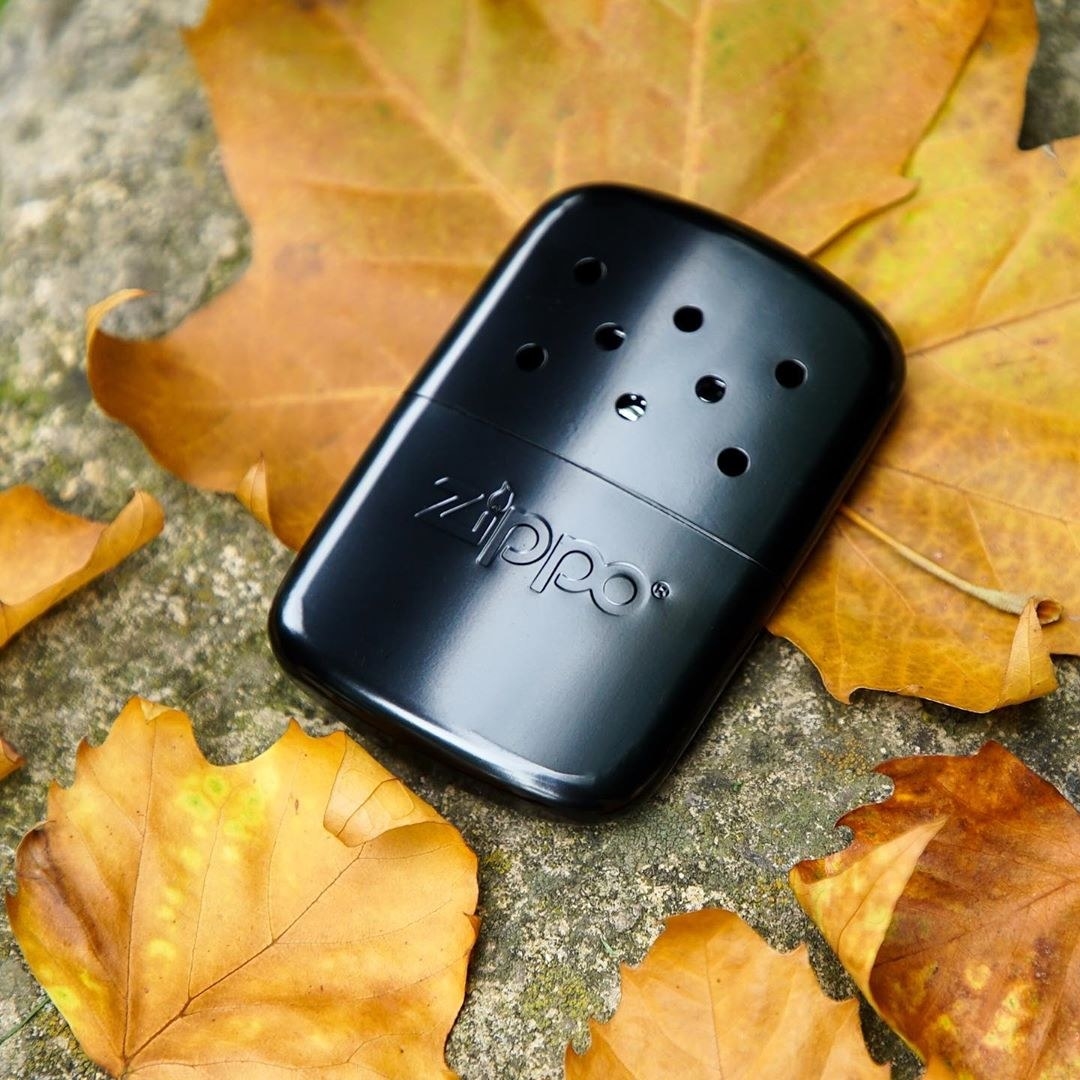 A zippo warmer on a pile of leaves
