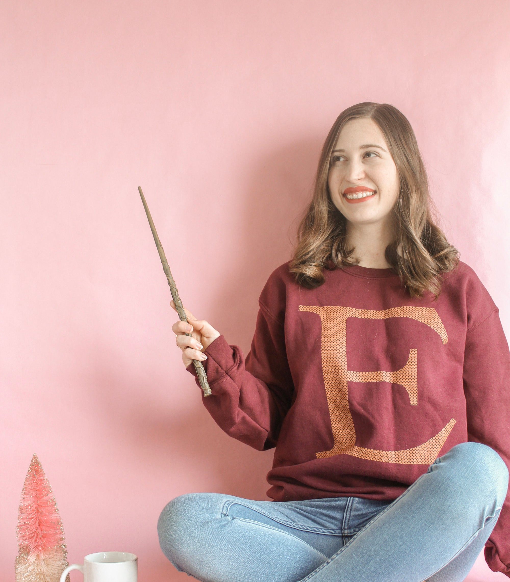 Model in the sweatshirt with letter E in Gryffindor colors