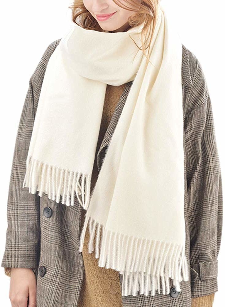 Model in the cream colored scarf with fringe