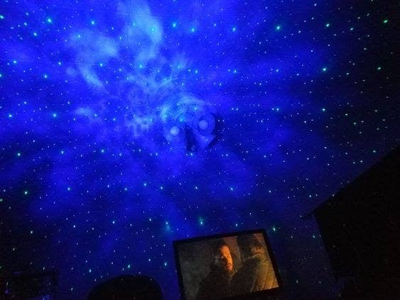 reviewer photo of the blue stars and night sky from the projector 