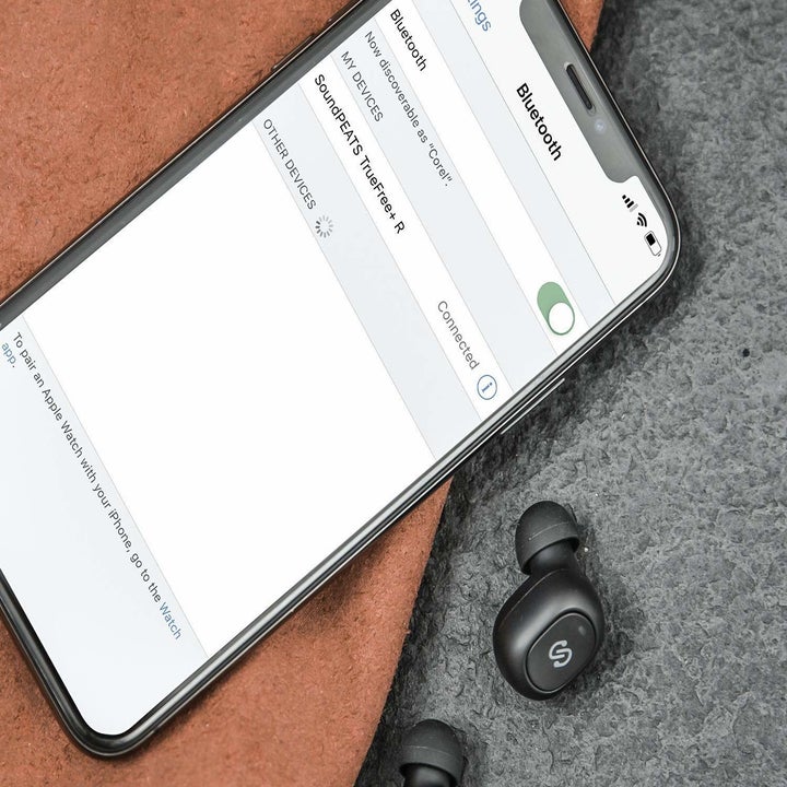 The earbuds next to a cellphone