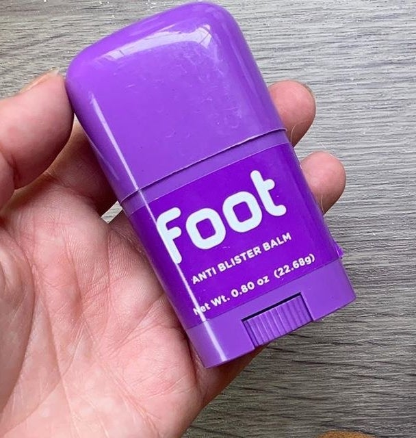 hand holding purple tube labeled &quot;foot anti blister balm&quot;