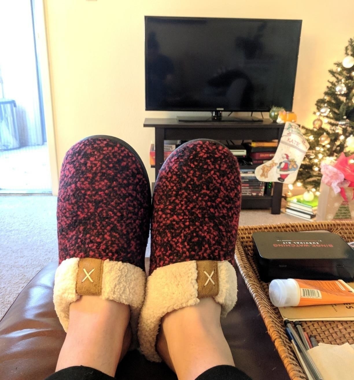 reviewer wearing the slippers in red 