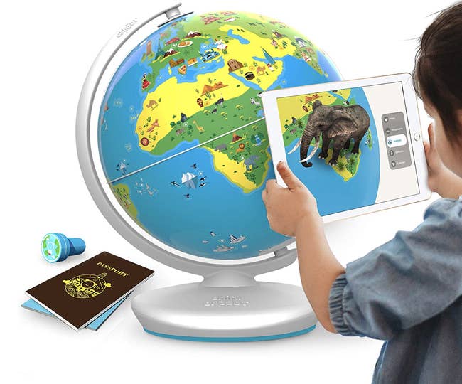 A model scanning the globe with an iPad which is displaying an elephant