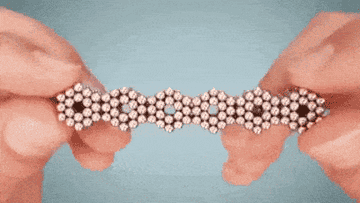 a gif of someone manipulating the beads into different shapes