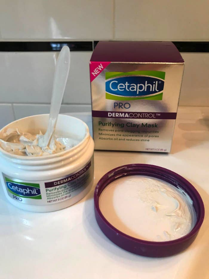 a tub of the Cetaphil clay mask with a plastic spoon sticking out of it