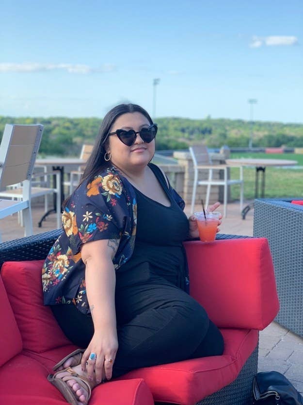 buzzfeed reader christineh491a2795d on a patio, wearing the black heart-shaped sunglasses