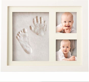 A framed footprint and handprint with baby photos