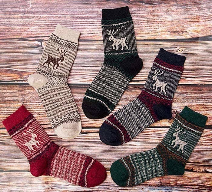 Going clockwise, the socks look like this: red print with a cream reindeer, cream print with a brown reindeer, dark green print with a cream reindeer, navy blue &amp;amp; red print with a cream reindeer, and a green &amp;amp; orange print with a cream reindeer.