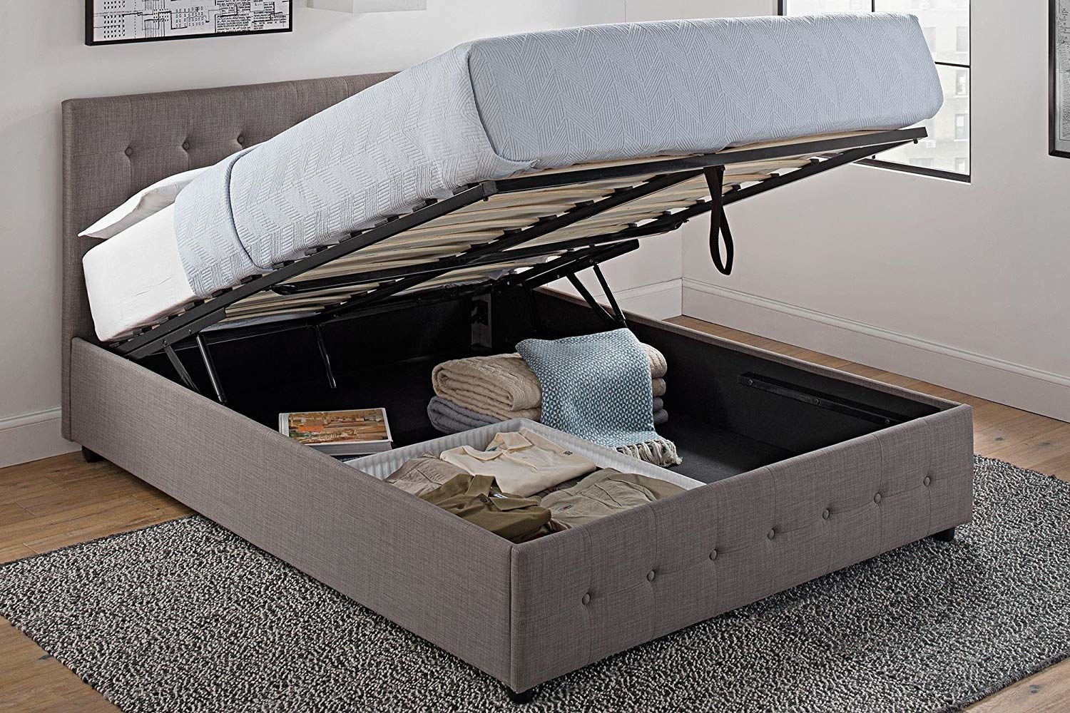 the grey linen bed open showing storage underneath