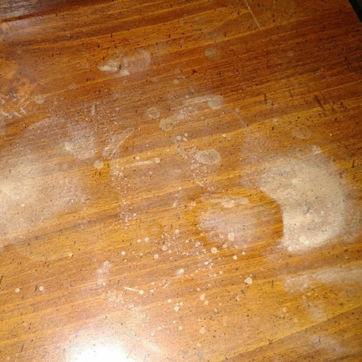A wooden table with mysterious discoloration. 