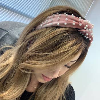 reviewer wearing the pink pearl headband 