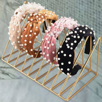 the set of four headbands in cream, mustard, pink, and black 