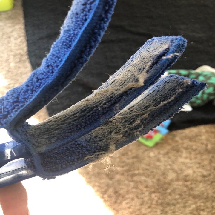 A customer review photo of the microfiber cloths covered in dust