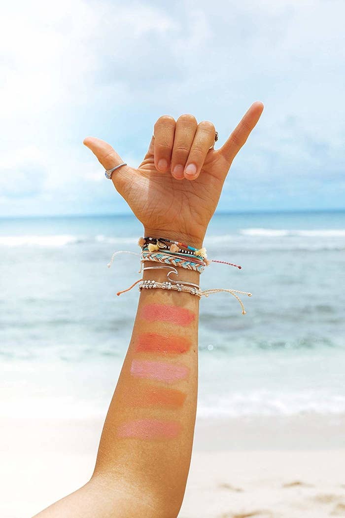 light skin tone  person&#x27;s arm with five pink-y swatched lip colors