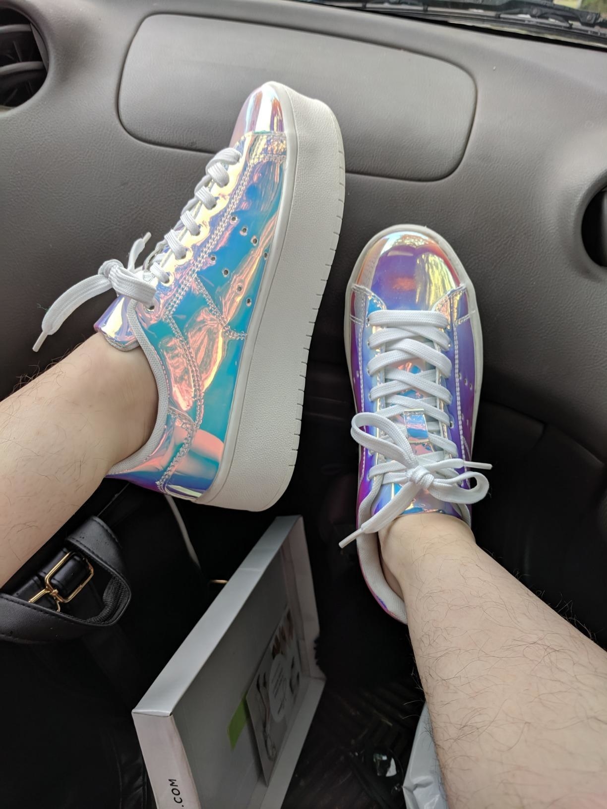 Reviewer pic of the shoes with a chunky white sole and shiny iridescent fabric all over the rest of the shoe