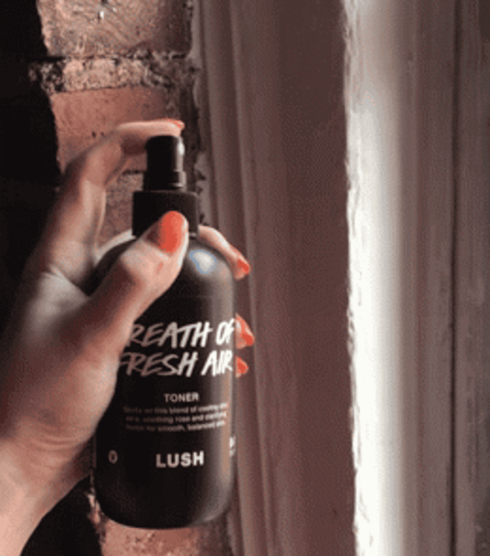 gif of a hand the toner spraying from its bottle