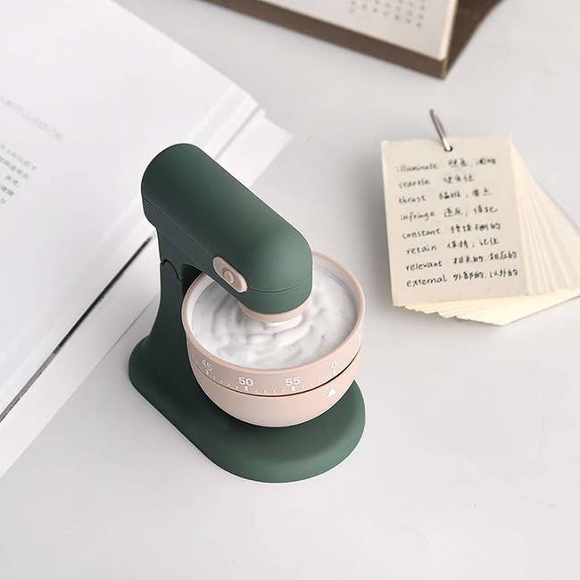 a small green timer that looks like a stand mixer