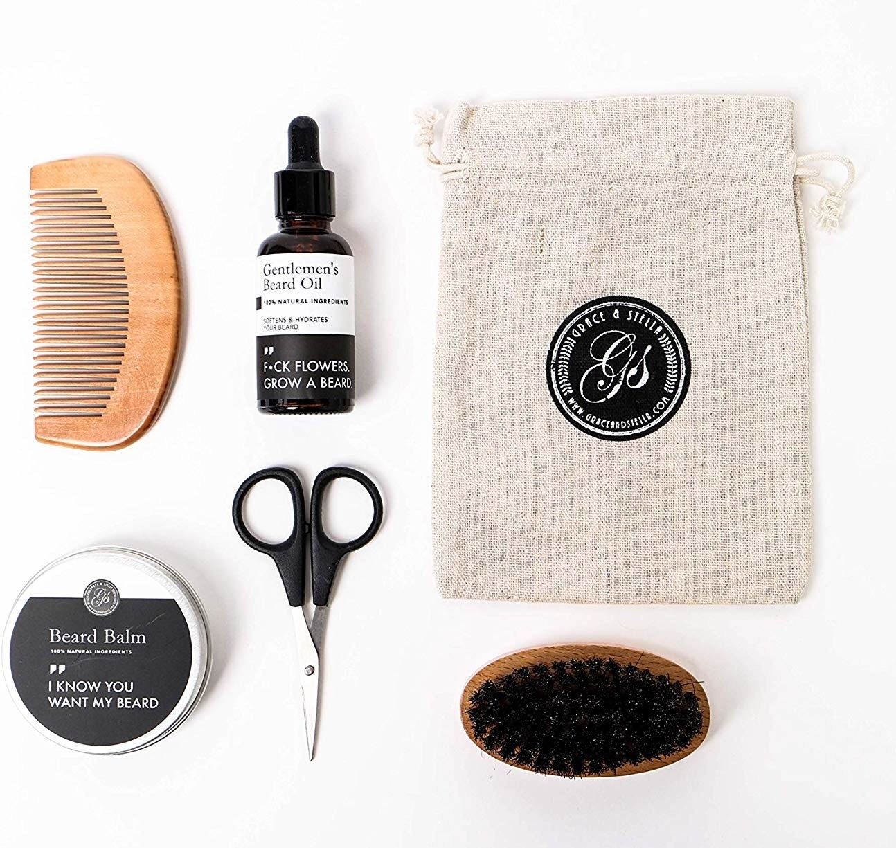 A flatlay of the beard kit that includes a pair of scissors, a beard brush, beard balm, beard oil, and a beard comb