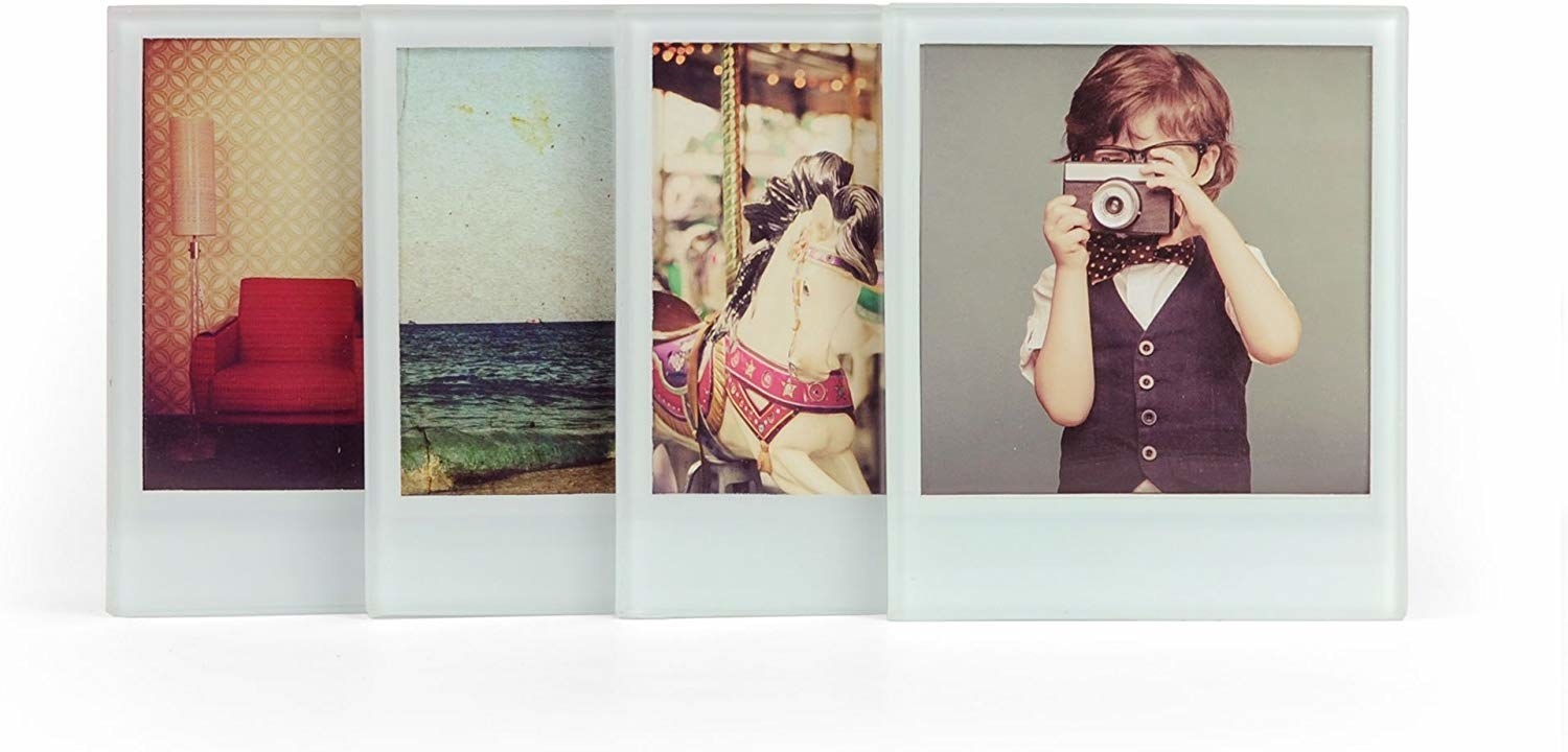 A set of four glass coasters with instant photographs inside