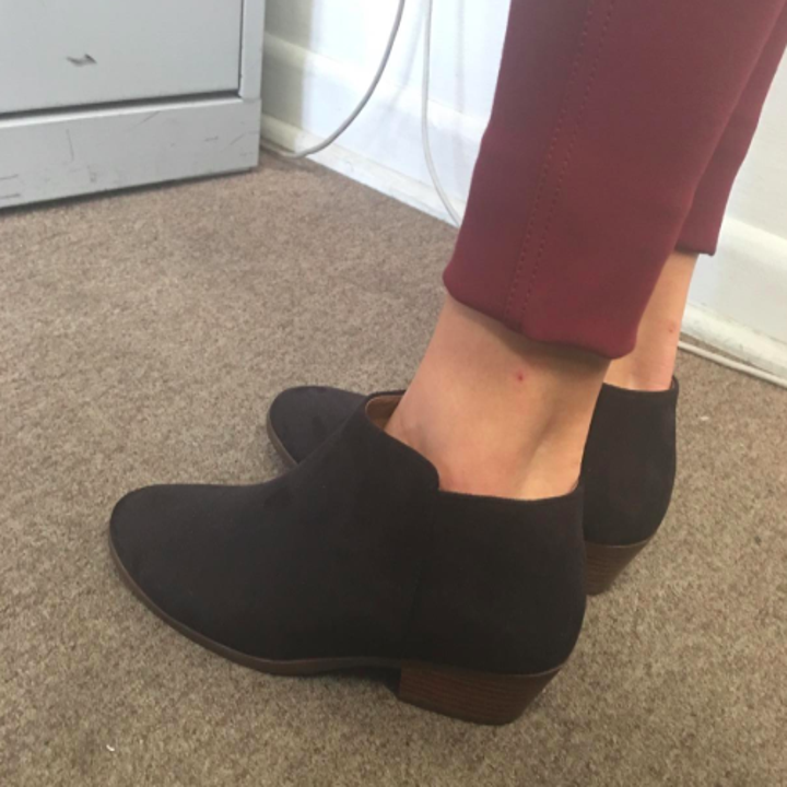 A customer review photo of a person wearing the ankle booties in black