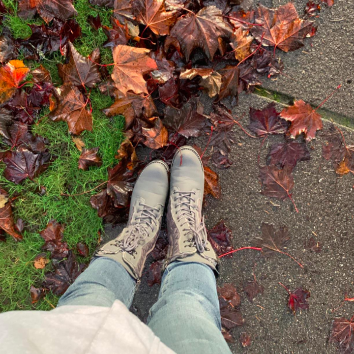 A customer review photo of a person wearing the waterproof mid-calf snow boots in gray