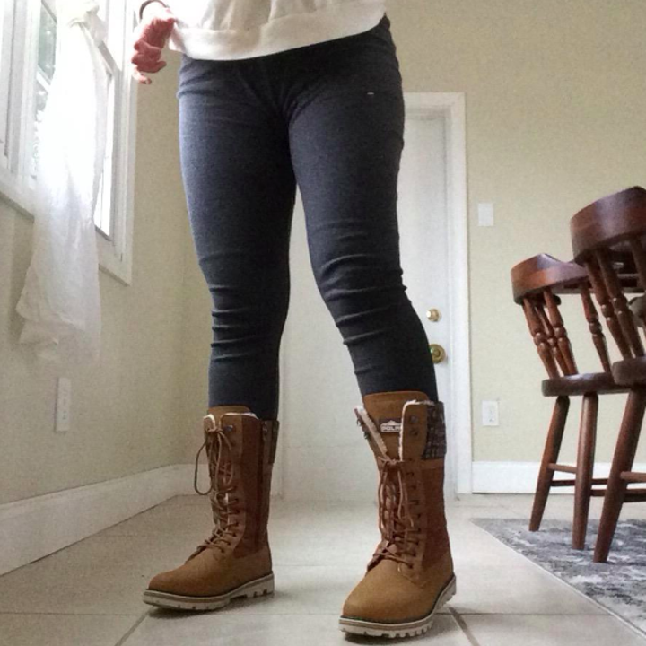 A customer review photo of a person wearing the waterproof mid-calf snow boots in tan