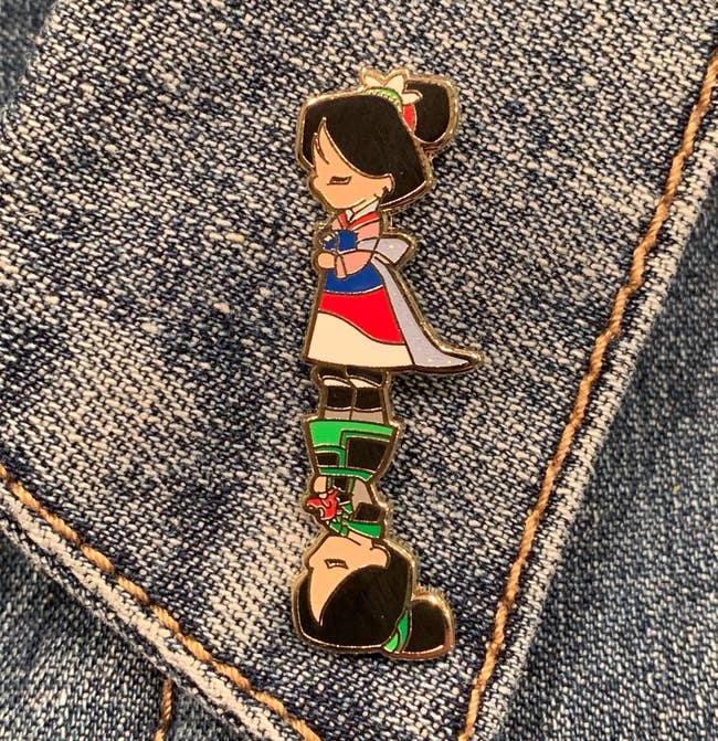 a pin showing mulan as a warrior on one half and mulan as a princess on the other